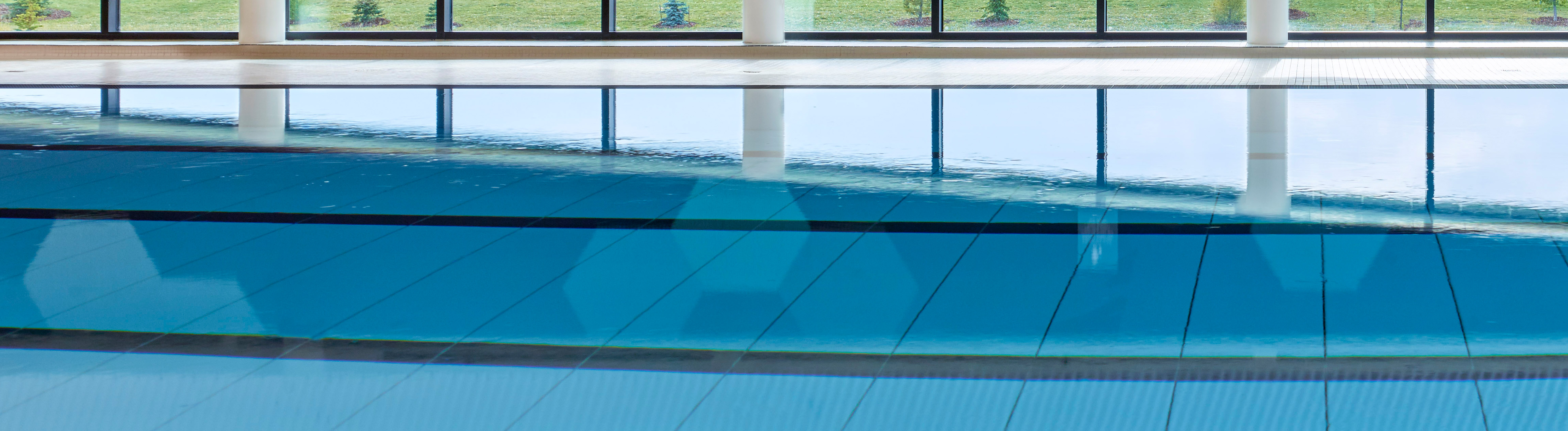 A close up of a movable floor under water in an indoor pool.